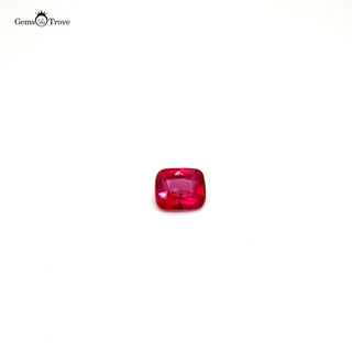 Close-up of a faceted no-heat ruby, highlighting its rich color on a white turntable.