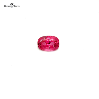 Close-up of a faceted pink spinel, highlighting its brilliance on a white turntable.
