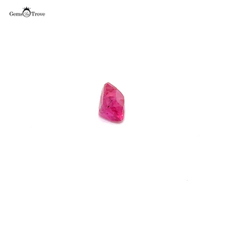 A rare untreated pinkish ruby in a rectangular cut, captured in high-resolution against a white background.
