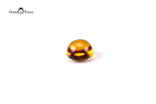 Round honey citrine cabochon, glossy surface on white background.