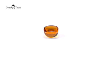 Cushion-shaped amber citrine cabochon, yellow edges, warm white backdrop.