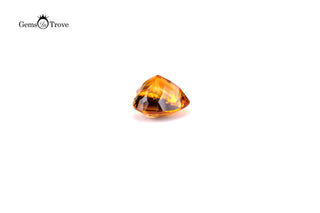 Heart-shaped orange citrine gemstone, glistening facets on soft white.